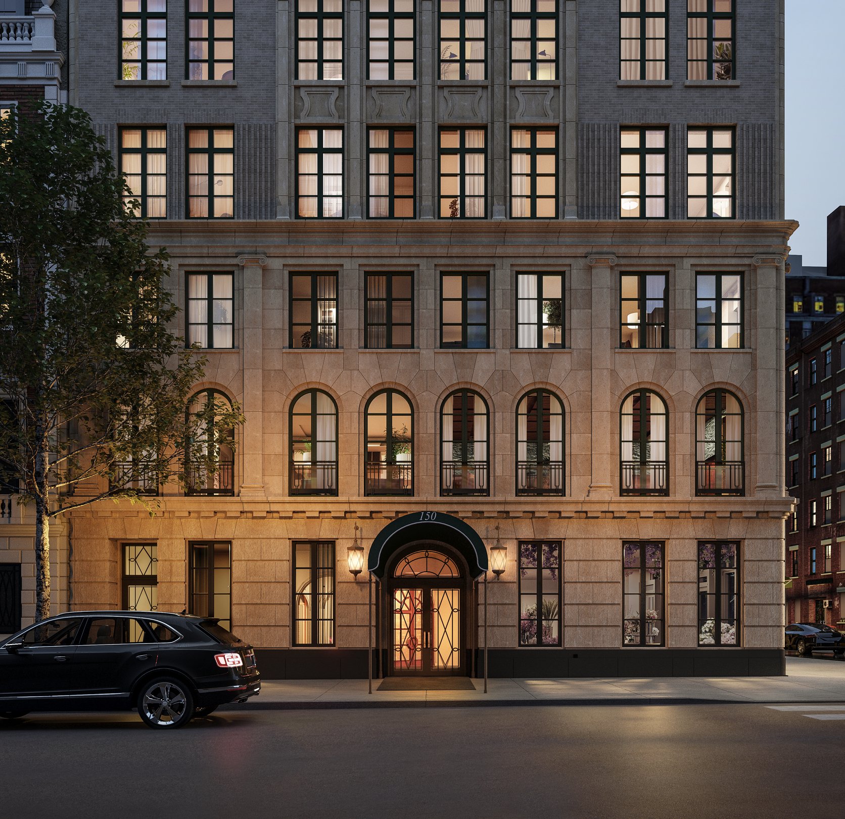An image of the front of the building with a small black SUV parked outside.